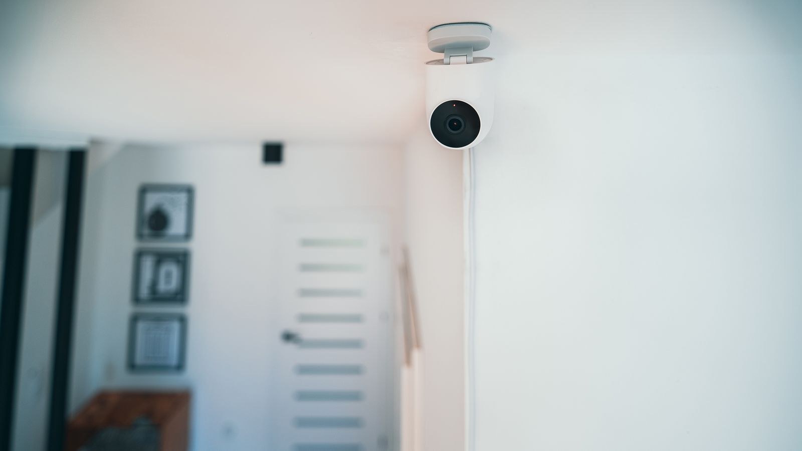 Indoor security camera mounted in a contemporary apartment living space