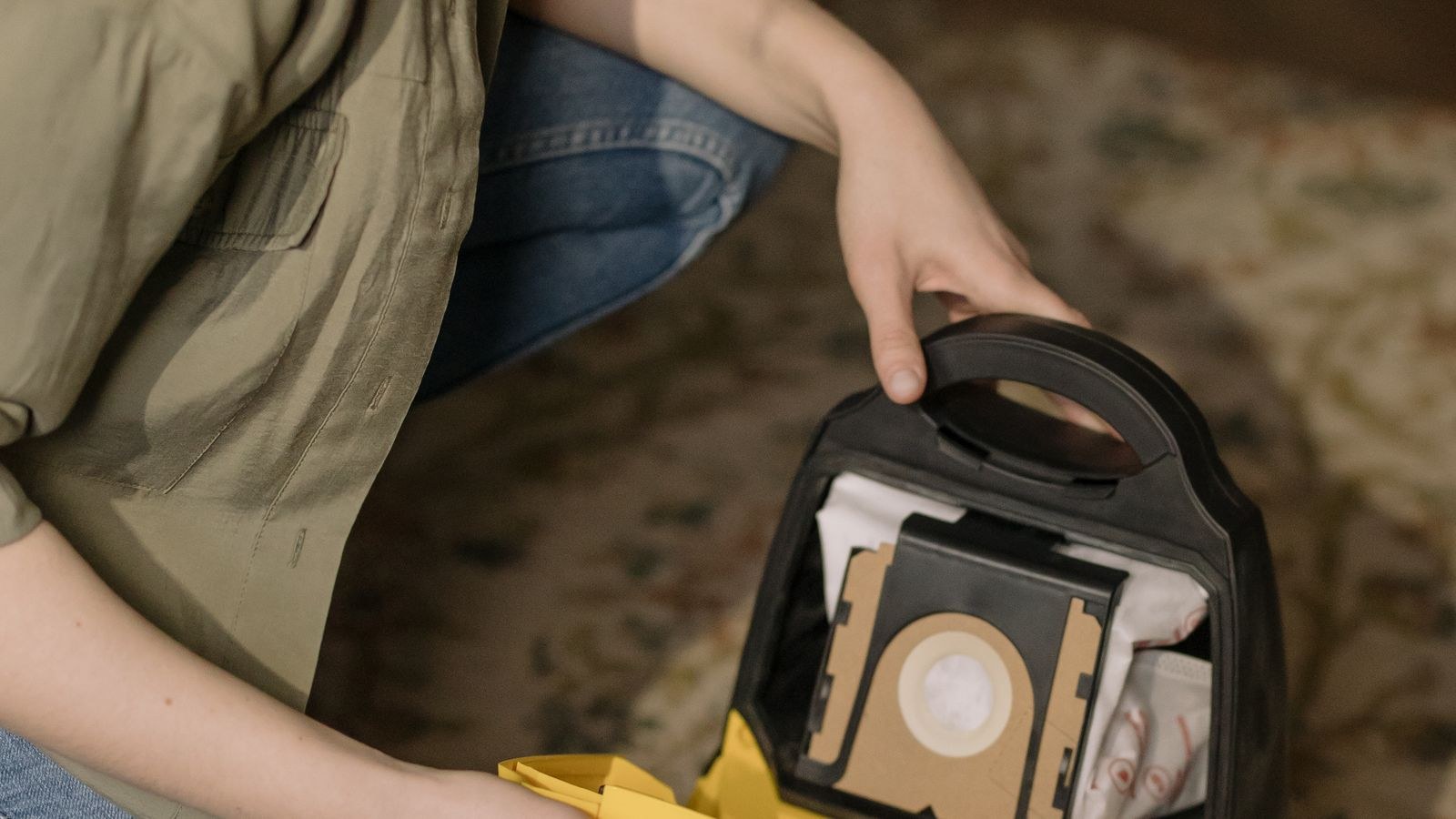 Close up of changing a vacuum cleaner dust bag during household maintenance