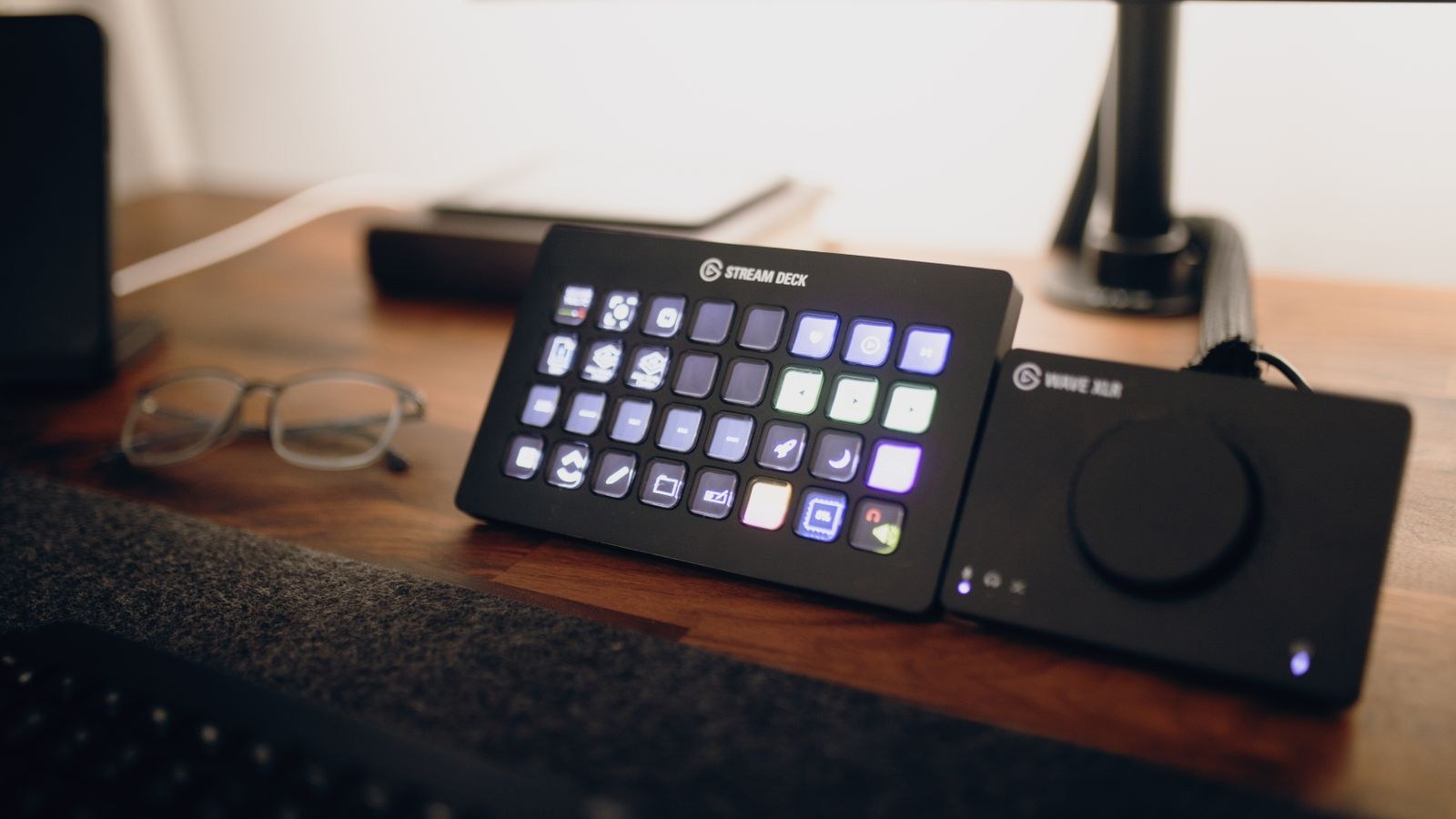Streamer at a lit desk setup with camera microphone and dual monitors