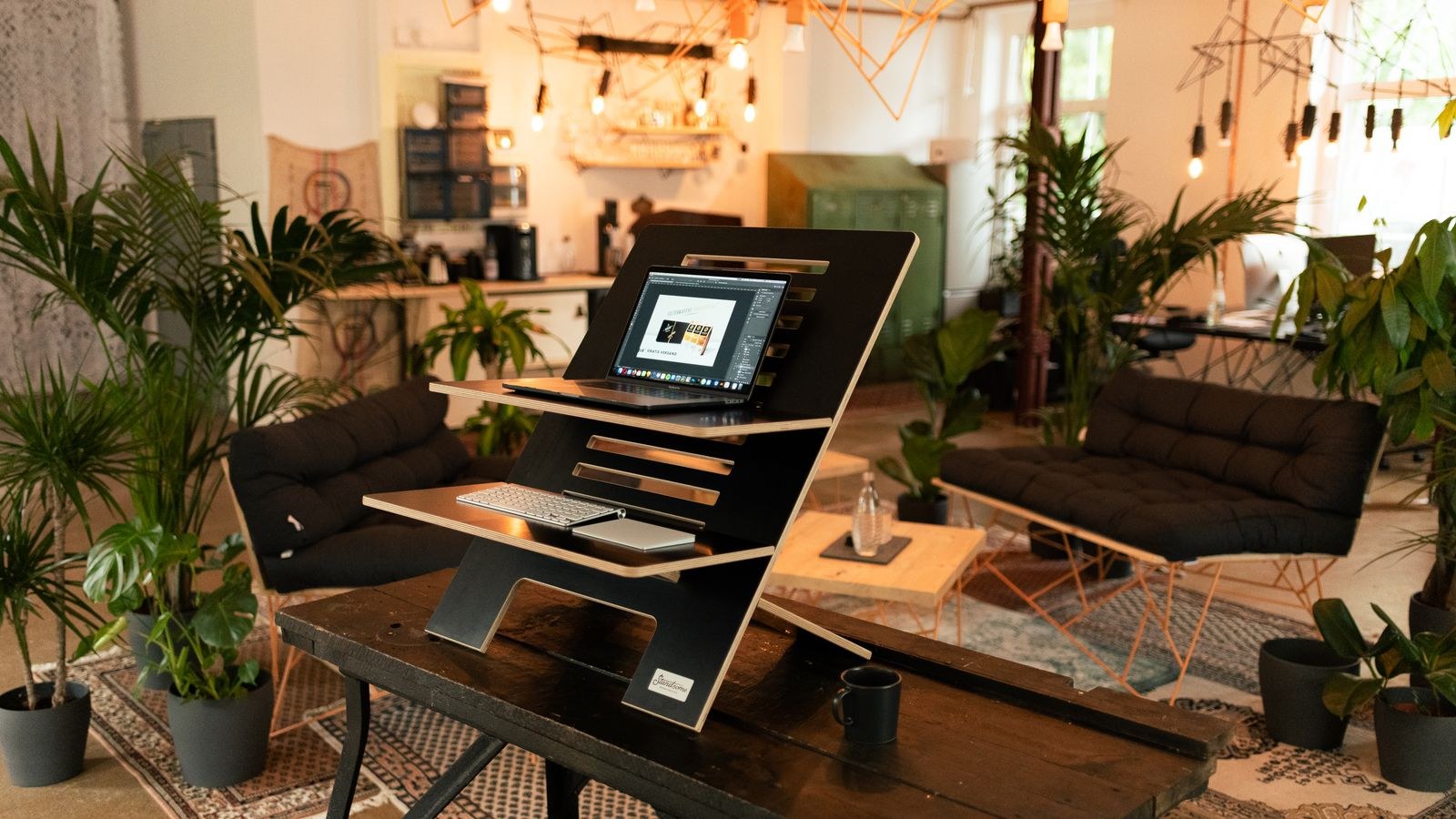 Stylish home office with a standing desk laptop and plants for a varied working posture