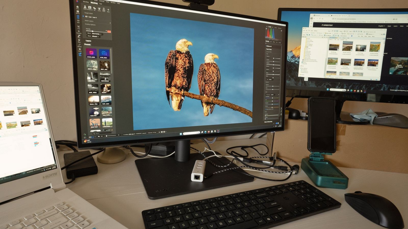 Photo editing workspace with calibrated monitors showing colour accurate images