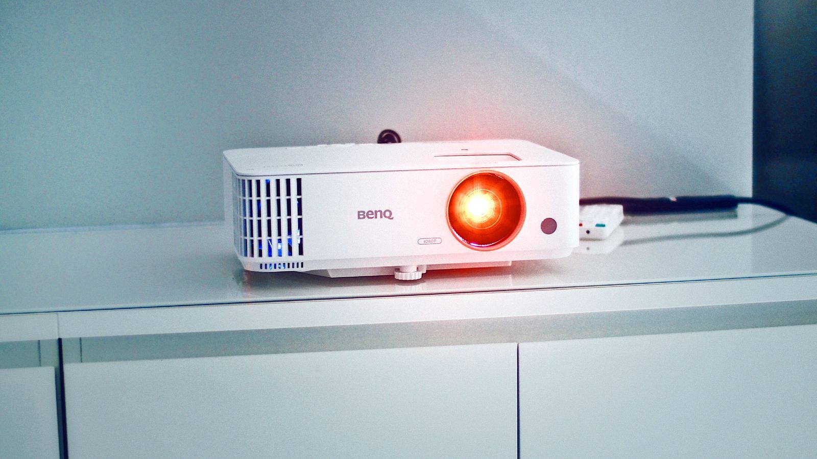 Ceiling mounted projector casting light toward a home theater screen