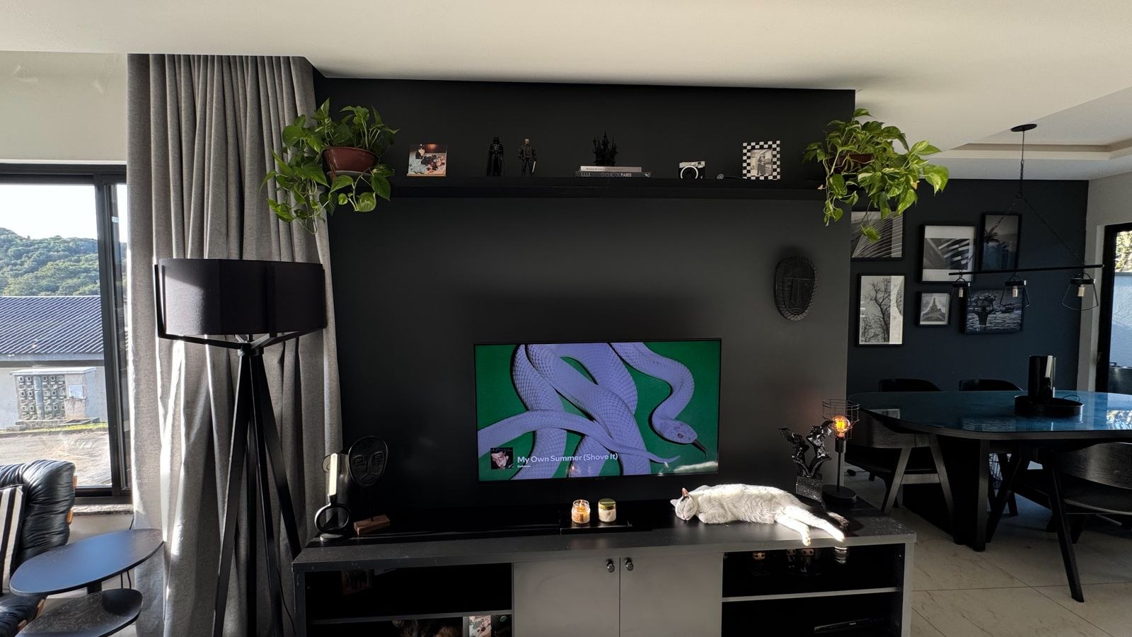 Living room television unit with speakers and decor beneath the screen