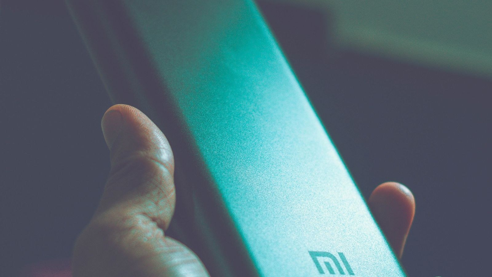 USB-C power bank charging a laptop on a desk