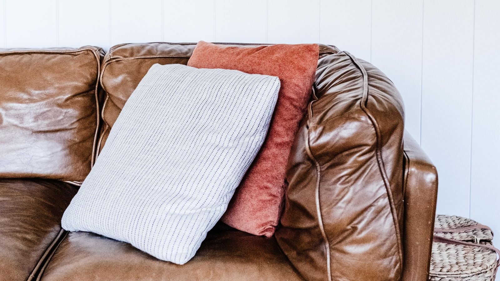 Brown leather sofa with cushions in a stylish modern home interior
