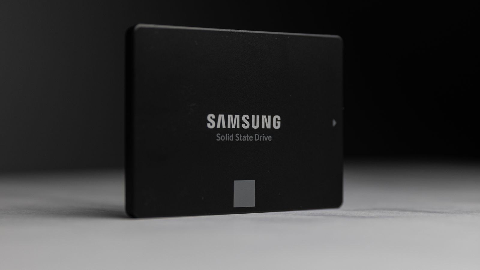 Solid state drive being inspected before replacement in a desktop computer