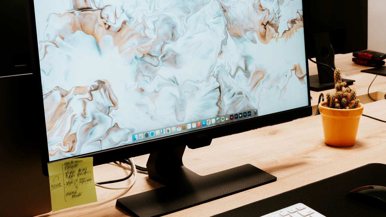 Clean desk setup with a computer monitor keyboard and mouse ready for screen cleaning