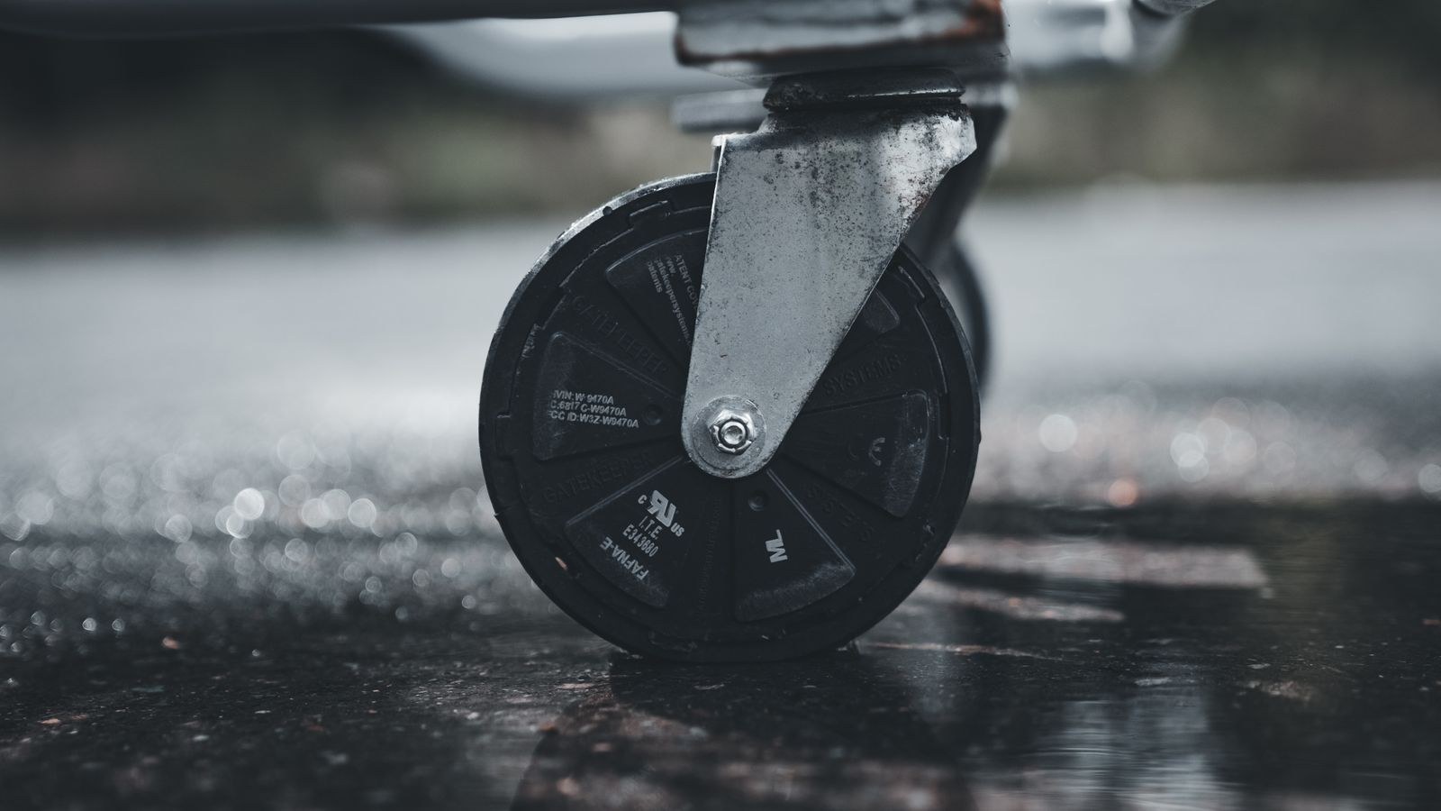 Close-up of a metal caster wheel showing its housing and axle