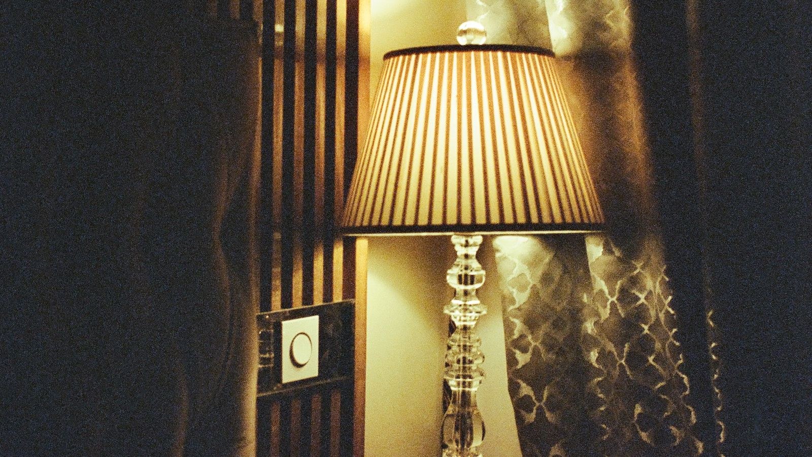 Dimmed bedroom lamp glowing warmly as part of an evening smart home routine