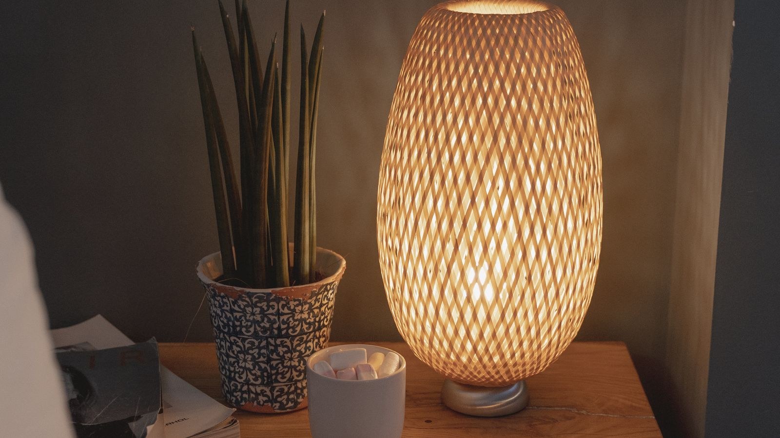 Cosy bedroom at night with soft smart lighting and a bedside table