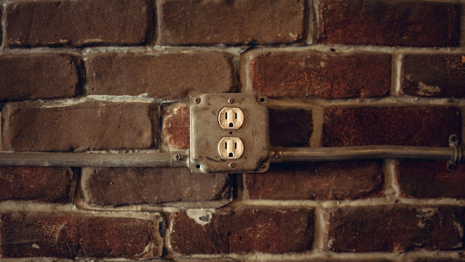 Wall outlet with two plugs inserted representing household standby power draw