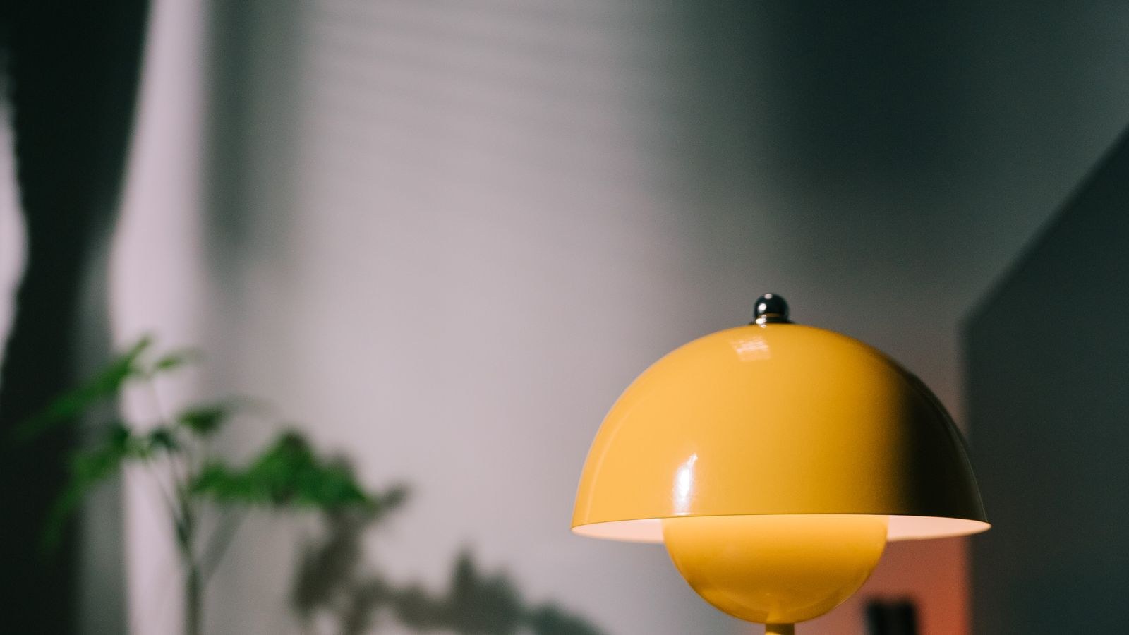 Bright desk lamp illuminating a minimalist home office workspace