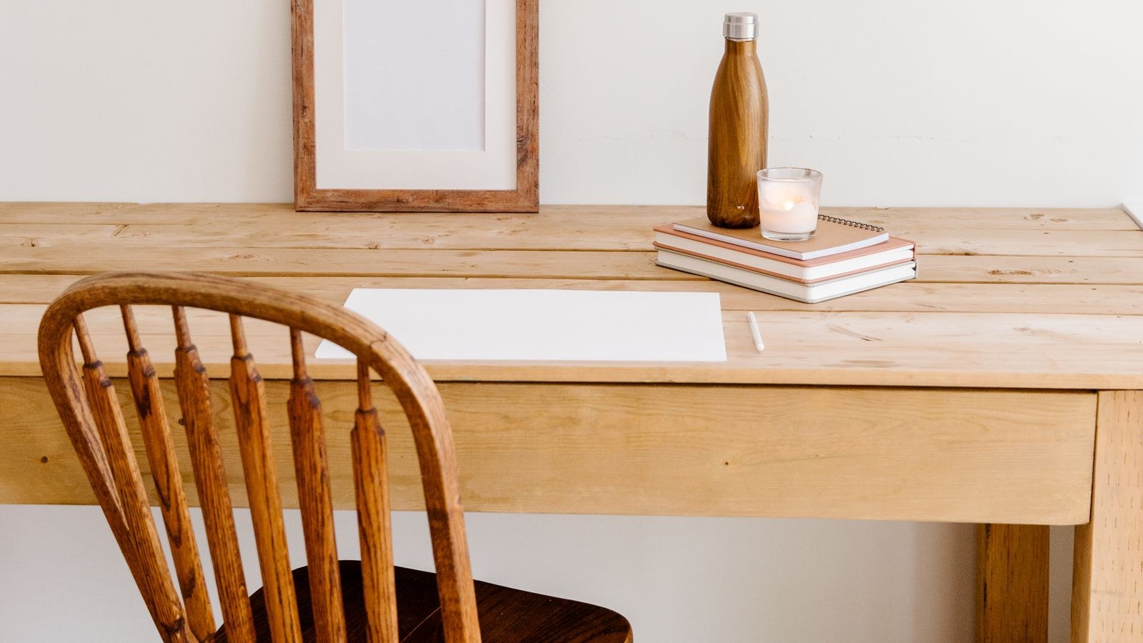 Minimalist workspace with a plain wooden desk top and simple decor