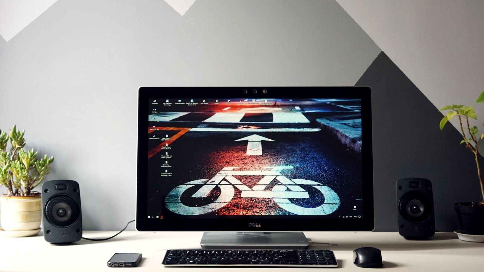 Desktop computer setup with a monitor surrounded by desk speakers