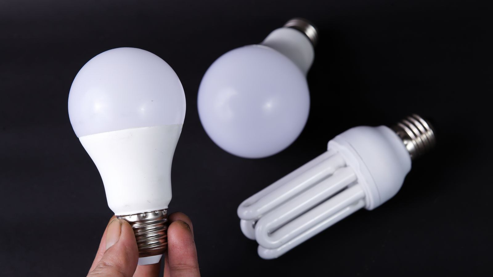 Close up of energy efficient LED light bulbs on a dark surface