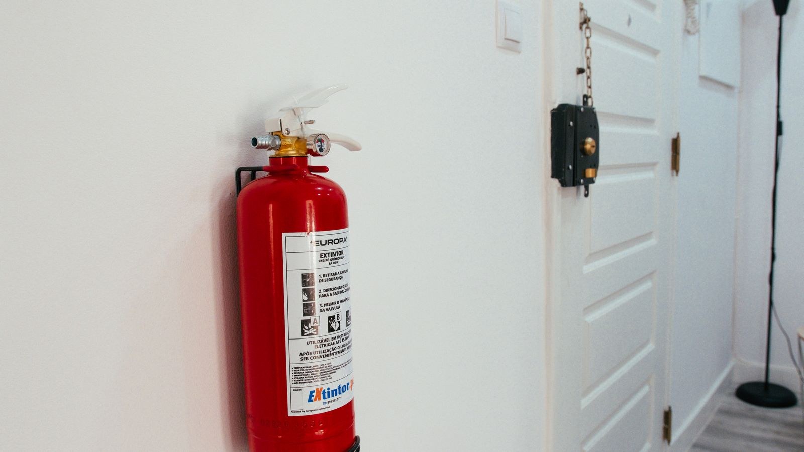Wall mounted fire extinguisher in a home hallway