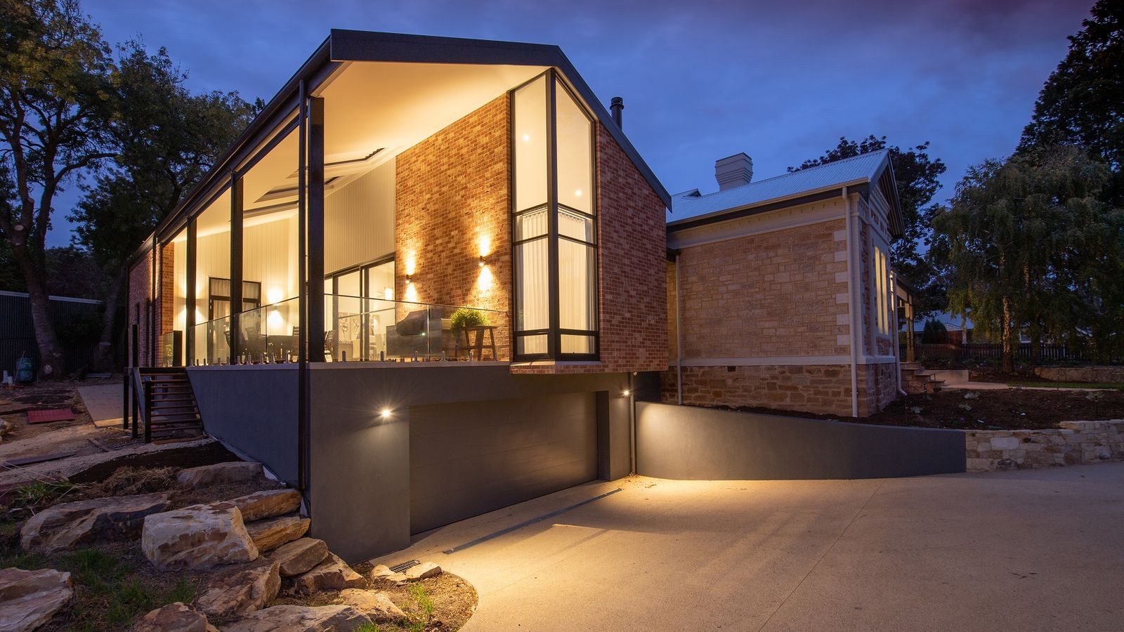 Residential exterior with pathway lamps providing night time security lighting