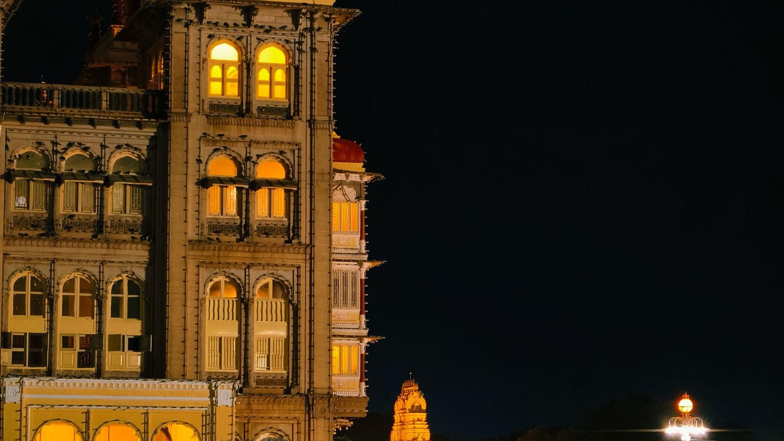 Large building facade lit by wide beam floodlights at night