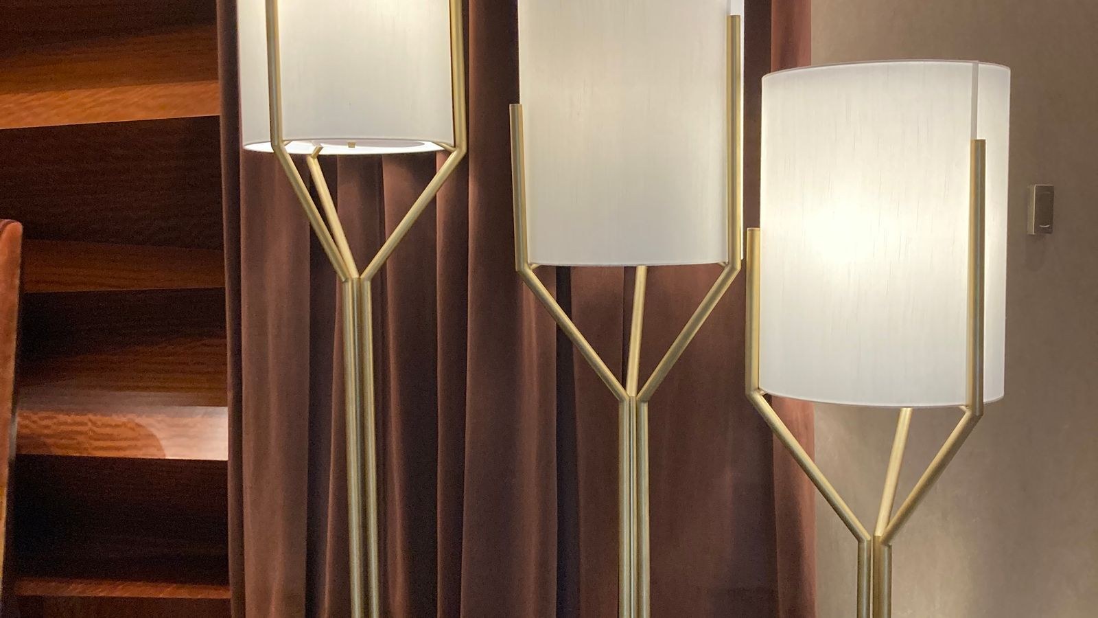 Contemporary floor lamps lighting a modern living room interior