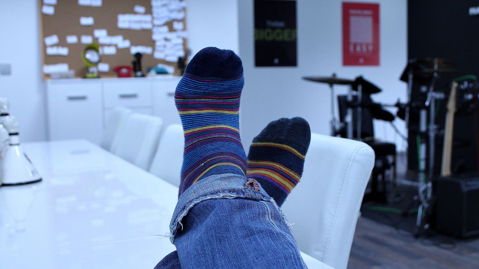 Person seated in an office with feet resting comfortably while working