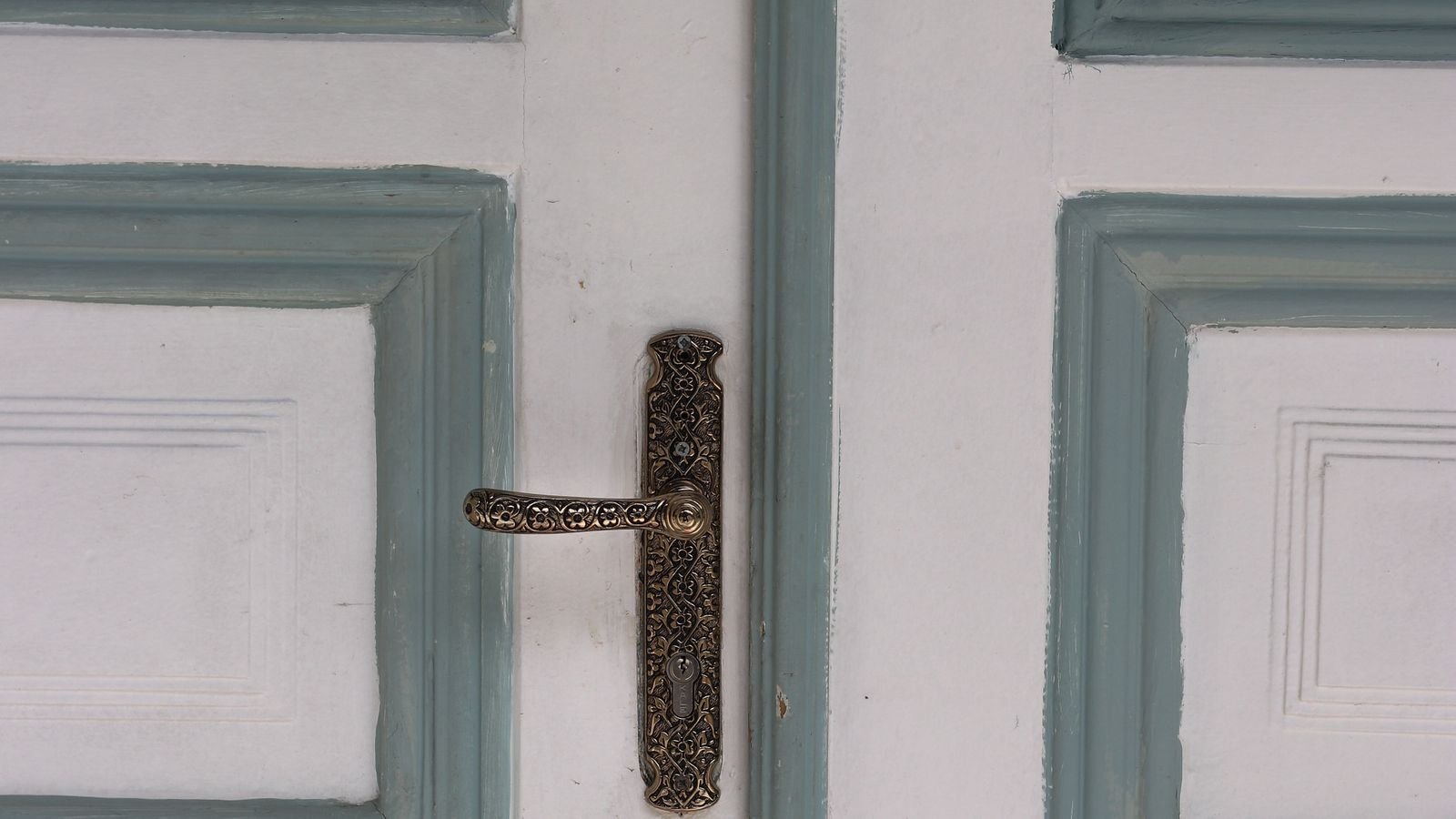 Close up of a key entering the cylinder of a front door lock
