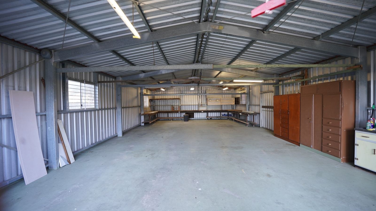 Well lit garage workshop with LED shop lights over a workbench