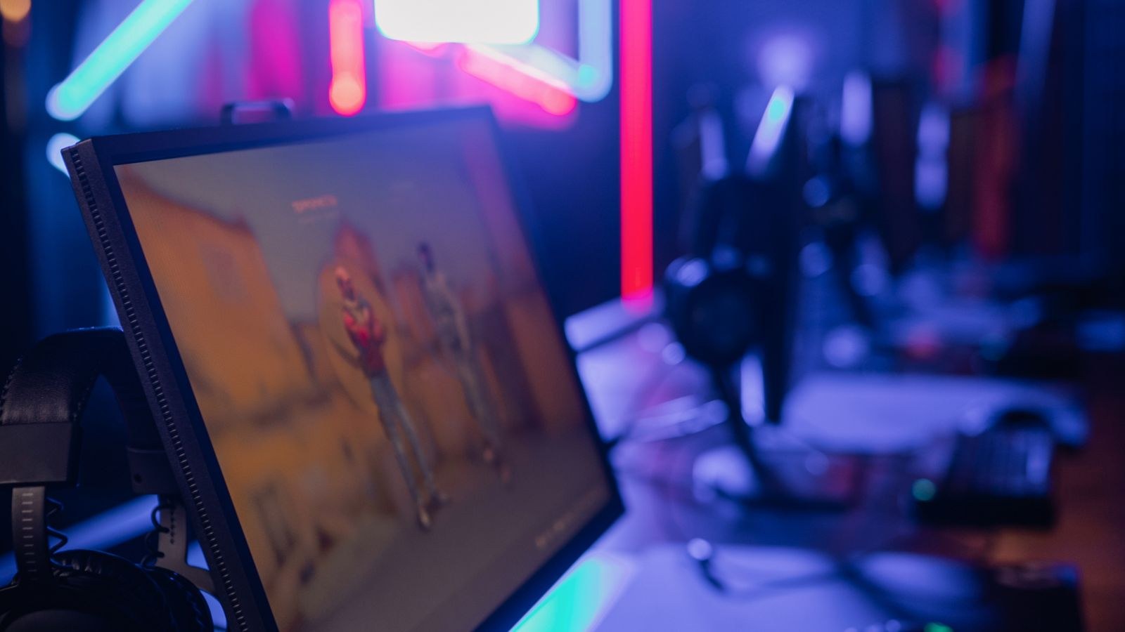 Modern gaming setup with neon lighting and a high refresh rate monitor