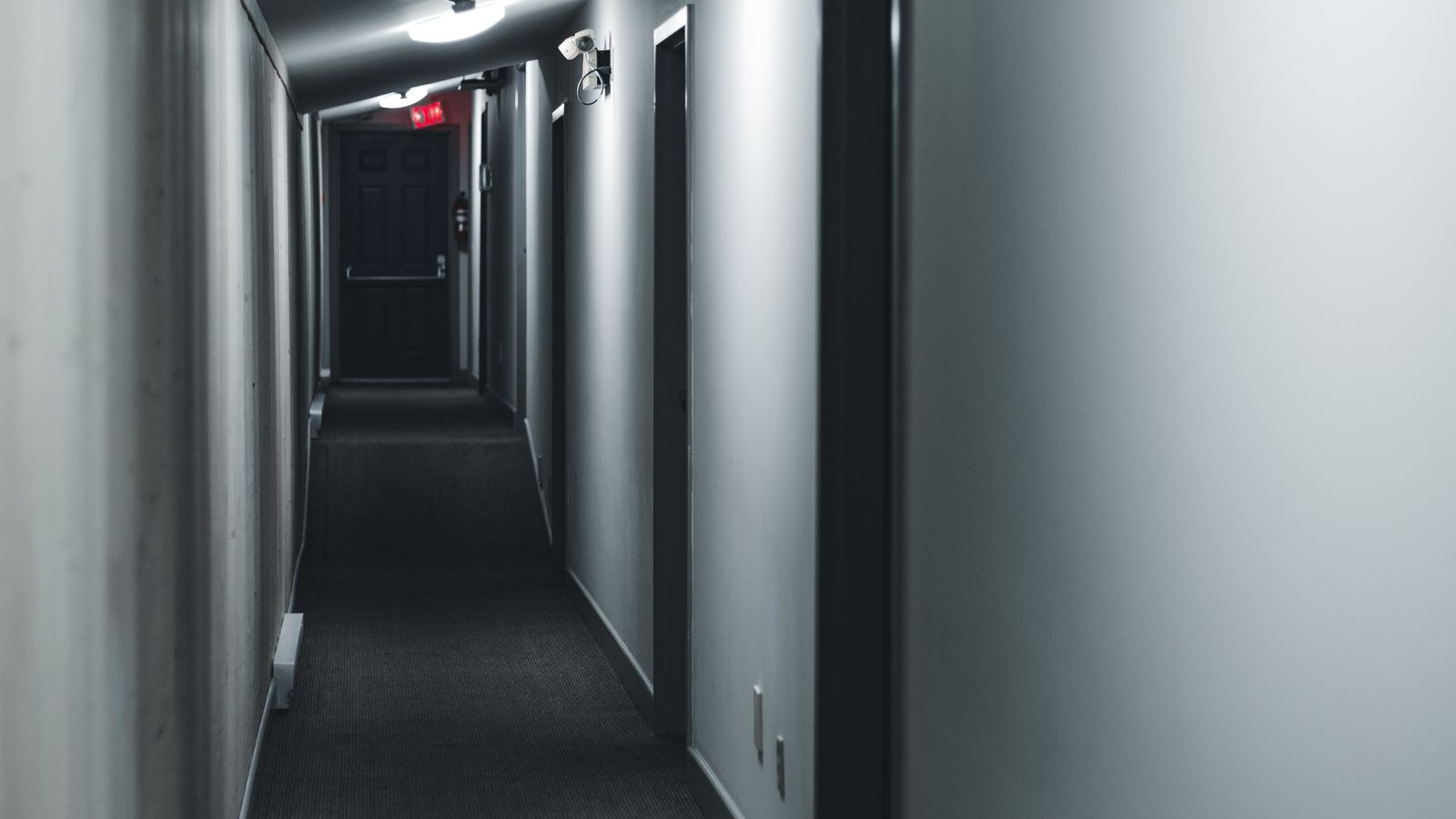 Dim hallway at night with soft low-level guidance lighting near the floor