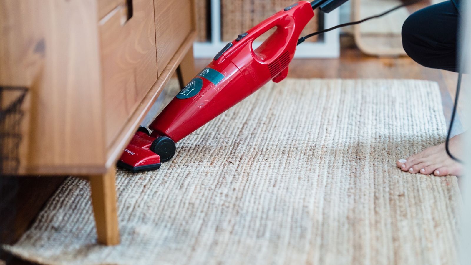Vacuum cleaner attachment cleaning the edge of a carpeted staircase