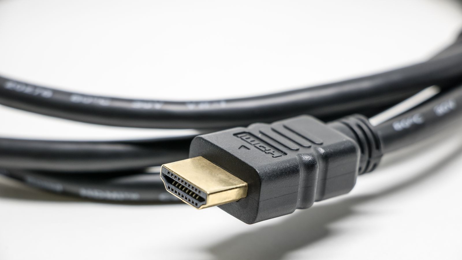 Black HDMI cable with gold plated connectors used for connecting a TV