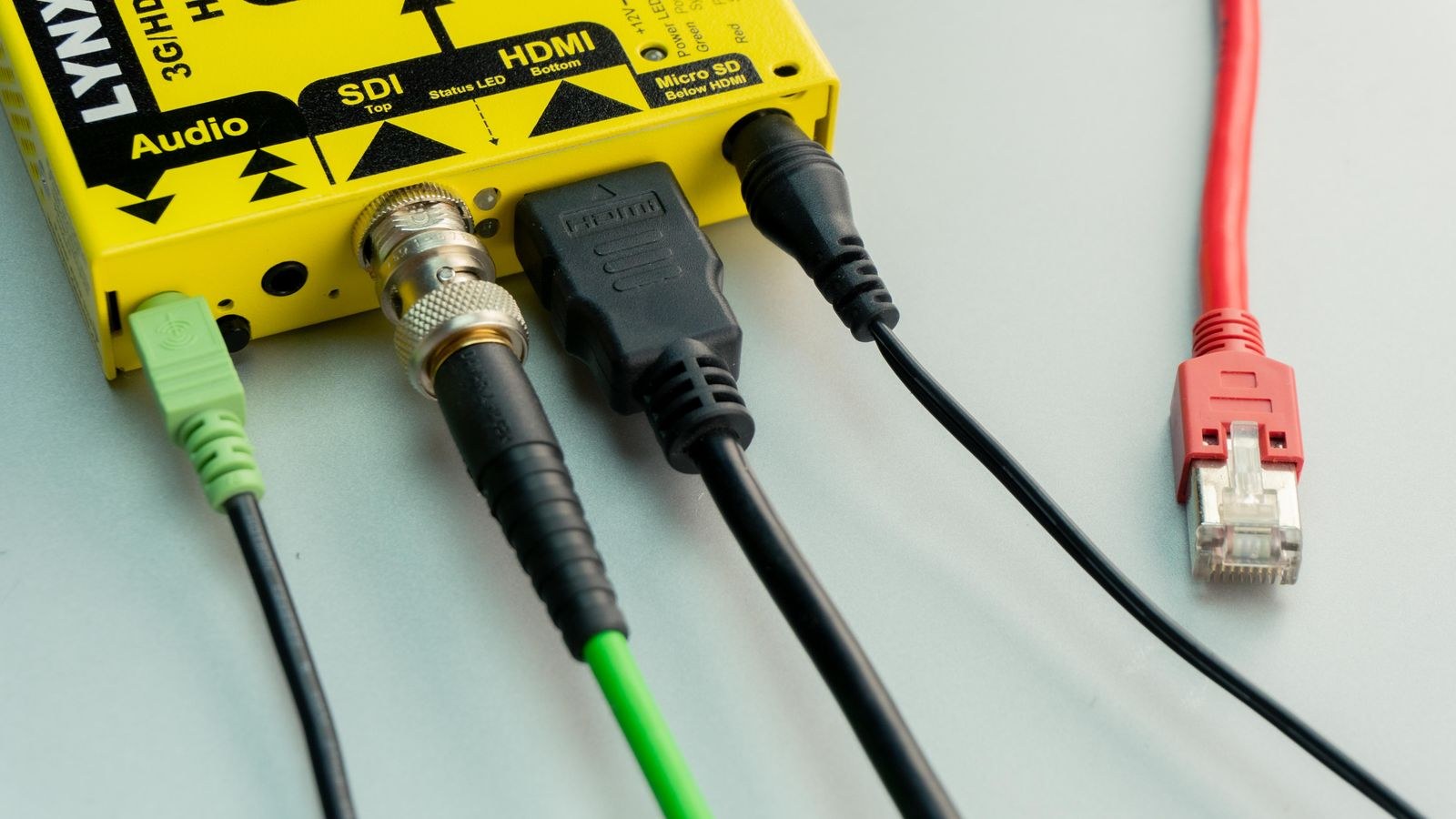 HDMI ethernet and audio cables connected to the rear ports of an AV device
