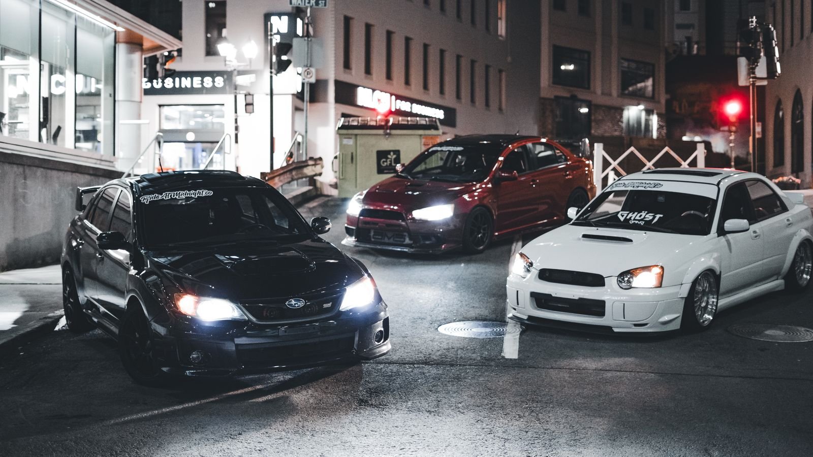 Bright car headlights illuminating a dark road at night
