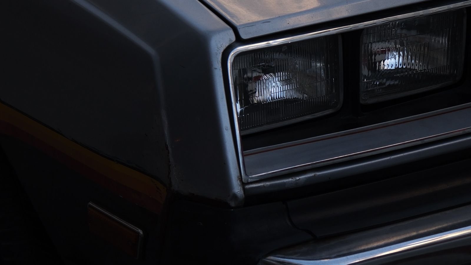 Automotive headlight bulb being installed in a vehicle housing