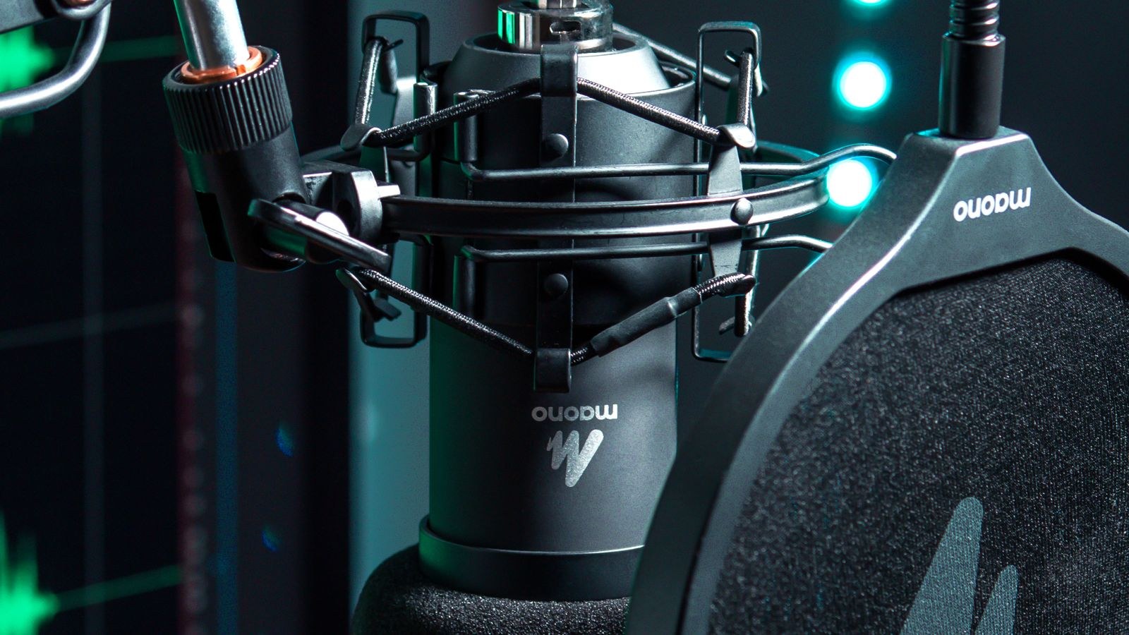 Studio microphone on a boom arm with pop filter above a desk