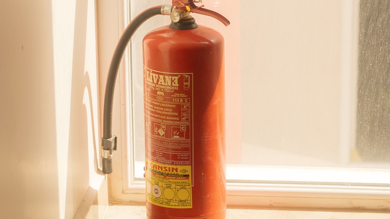 Fire extinguisher and safety equipment stored in a home garage