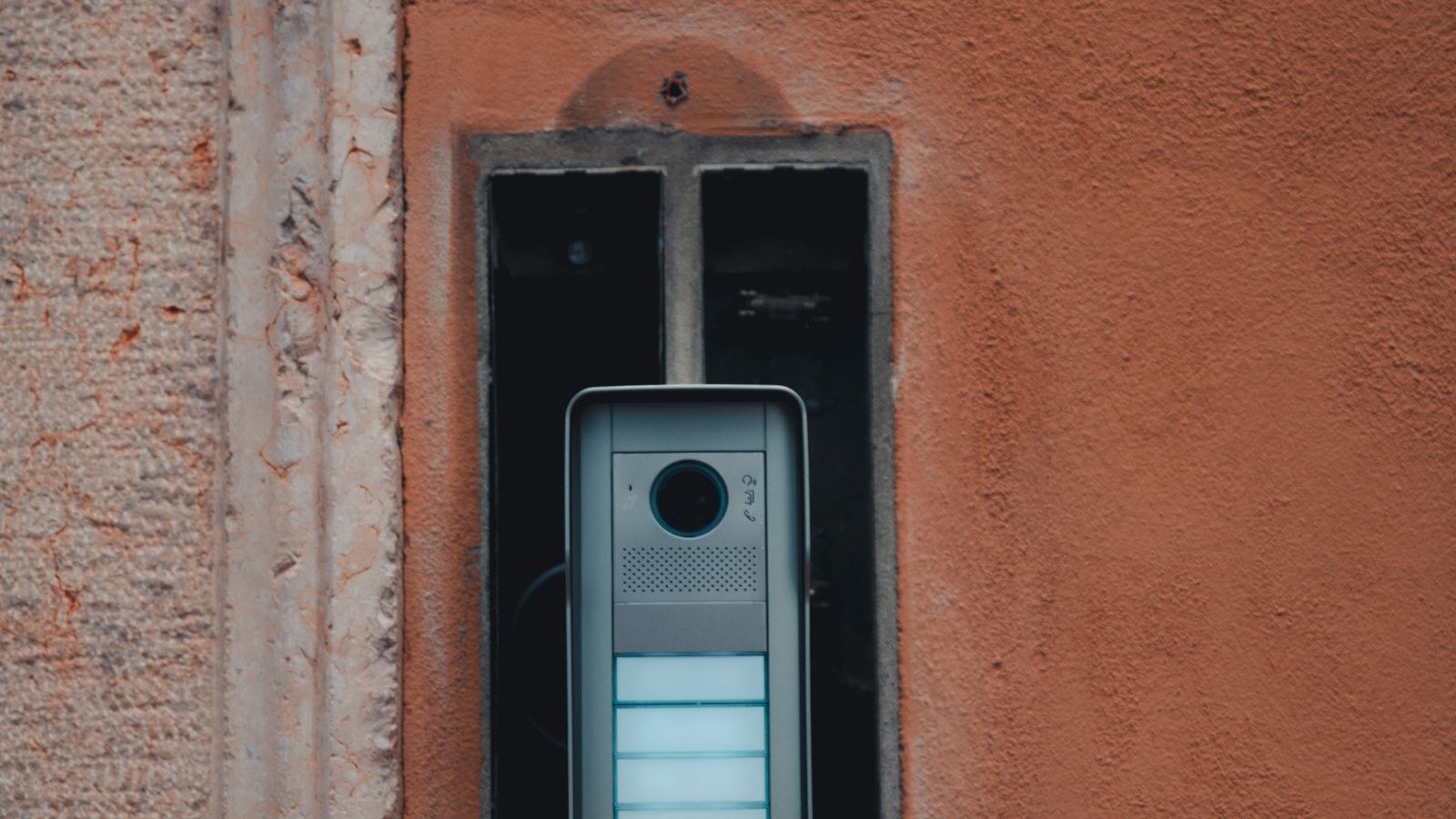 Modern wall-mounted doorbell chime unit installed in a hallway