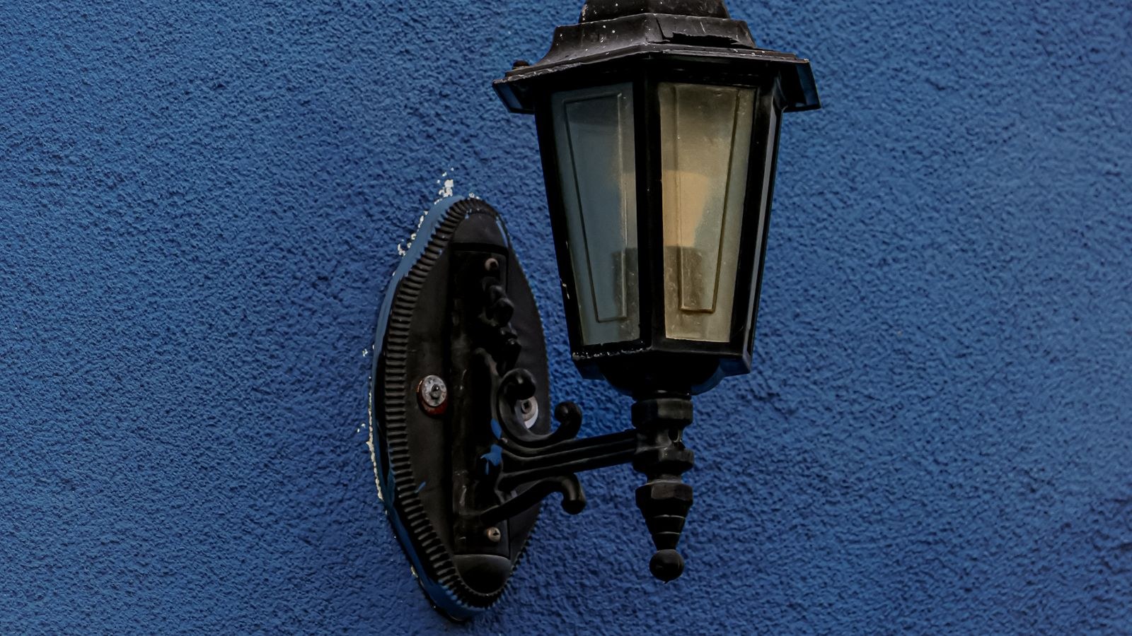 Exterior LED motion sensor light illuminating a driveway at night