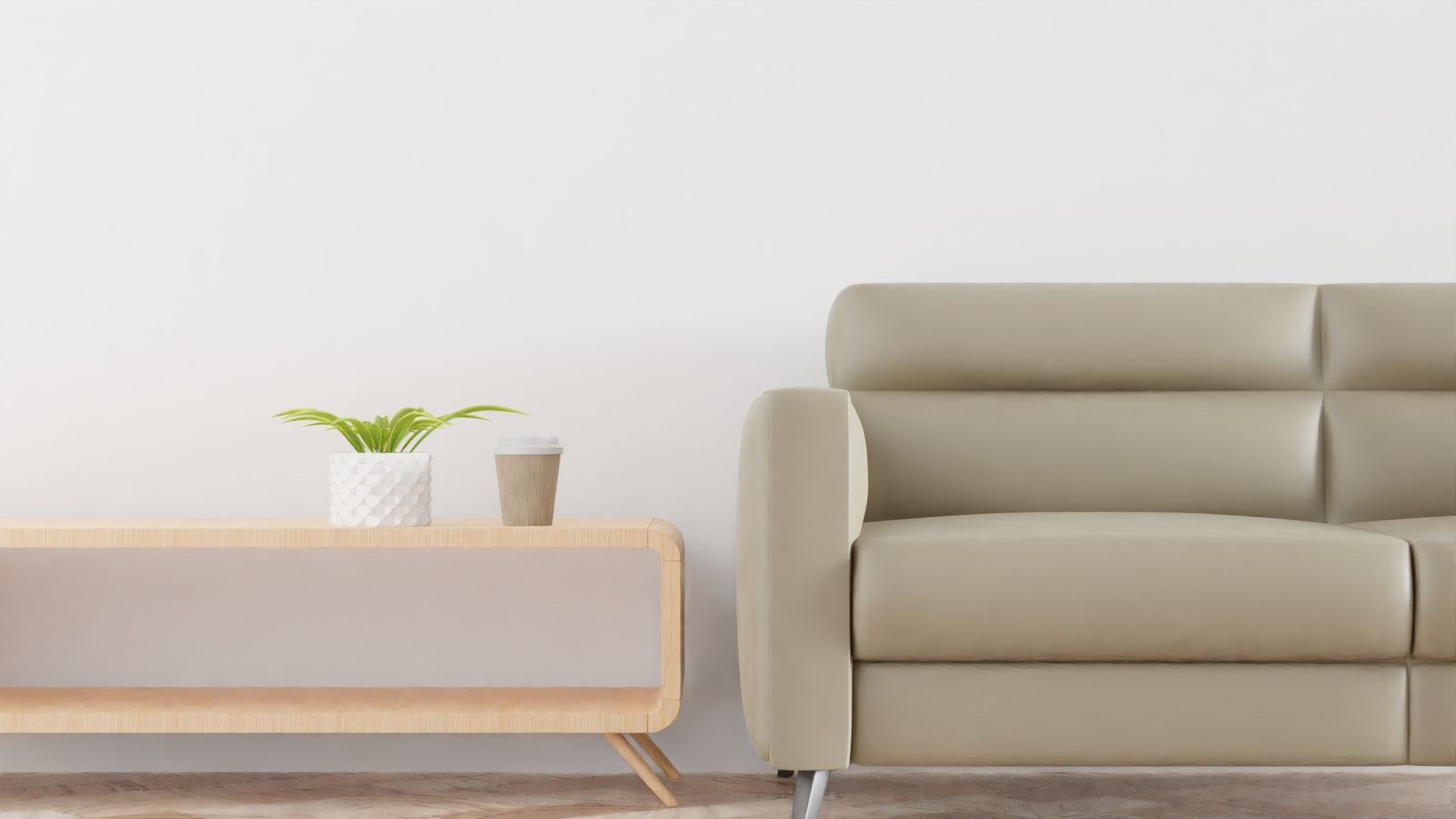 Small living room with a beige sofa, plant and wooden coffee table