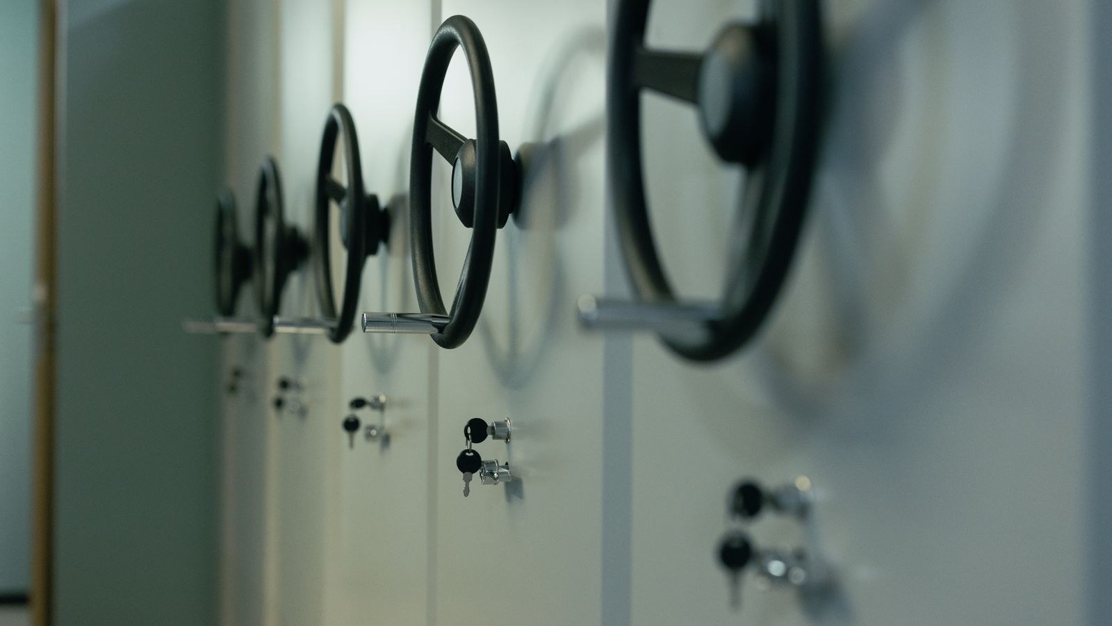 Row of industrial steel safes with manual locks and anchor points
