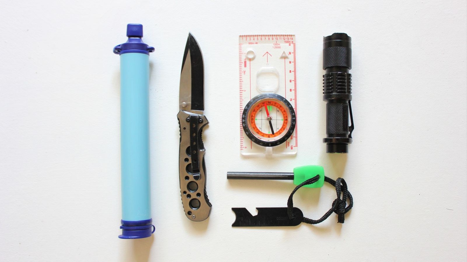 Organized survival kit essentials laid out for a three day home emergency supply
