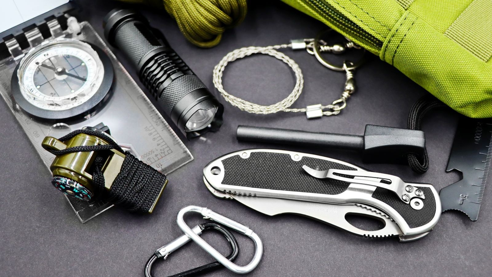 Emergency preparedness tools including flashlight compass and knife for a home disaster kit