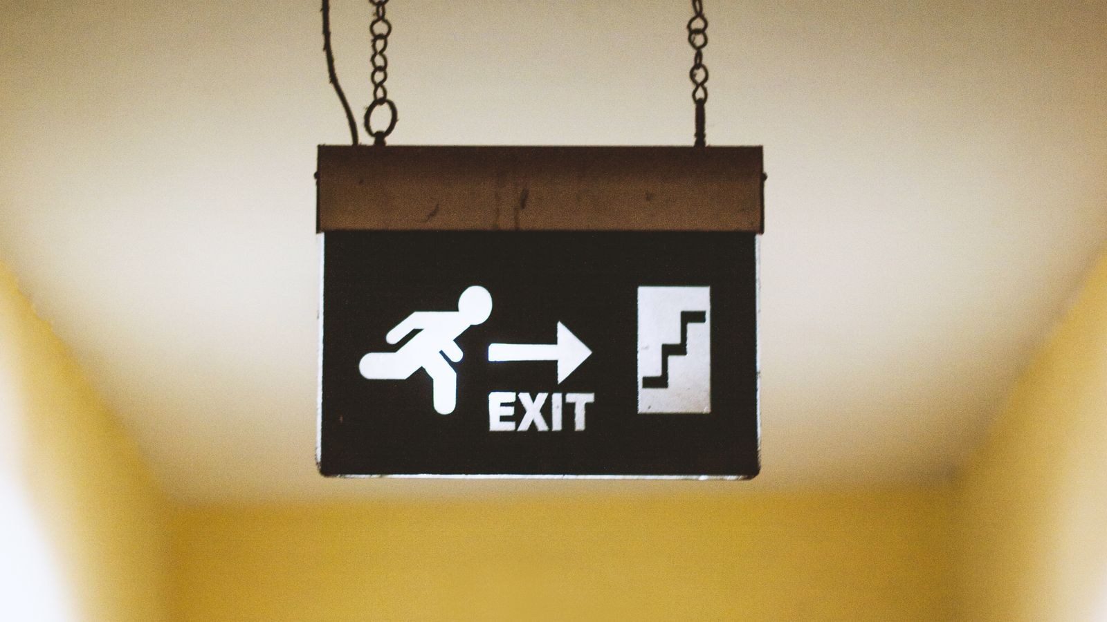Exit sign with running figure symbol marking an escape route indoors