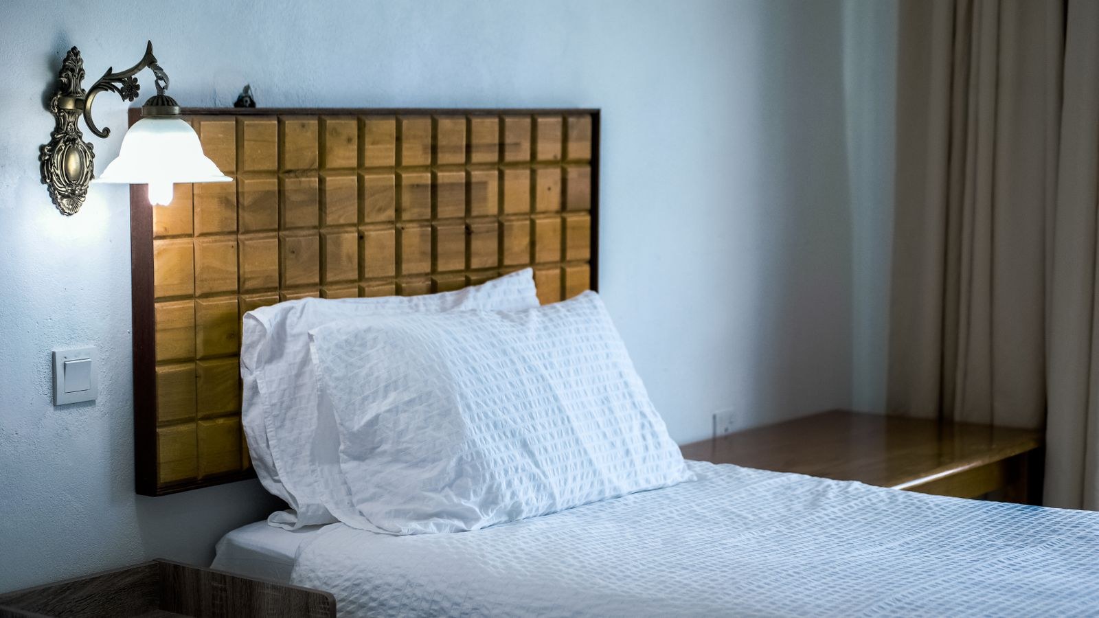 Rental bedroom interior being checked for concealed cameras and devices