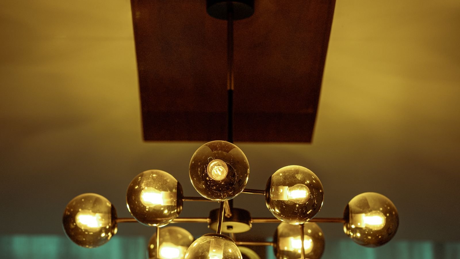 Crystal chandelier with multiple candelabra bulbs in a dining room