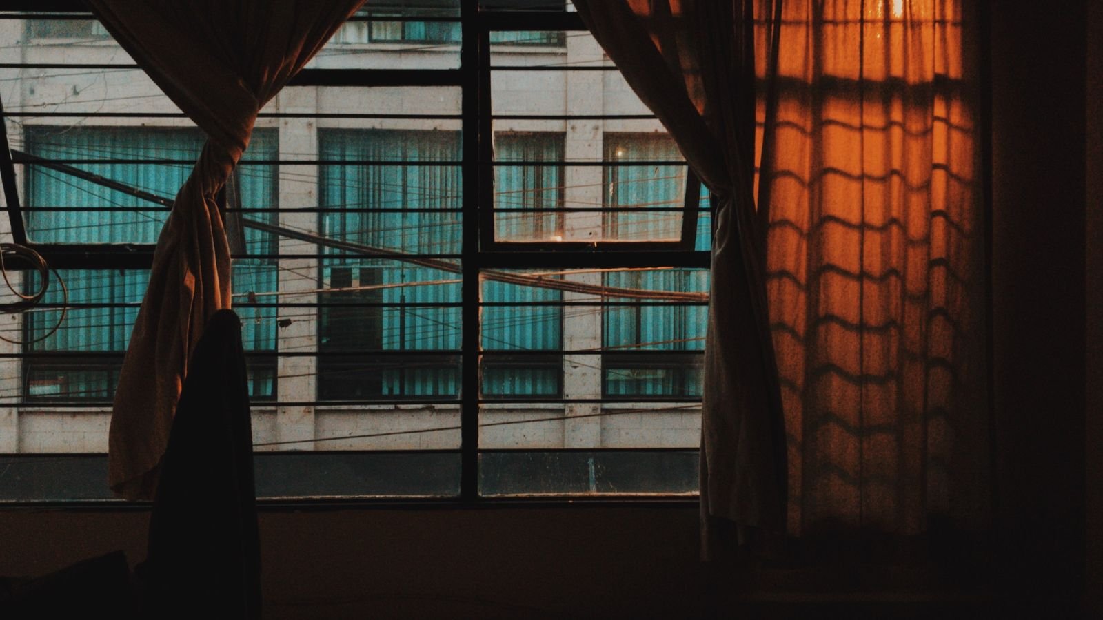 Wide curtain panels framing a large window in a modern room