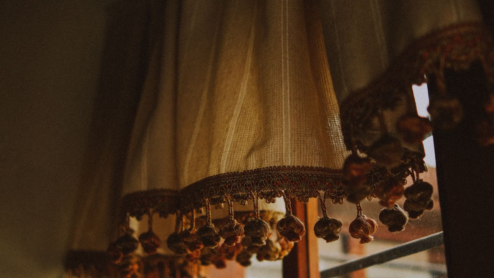 Long curtain rod bracket mounted above a wide picture window
