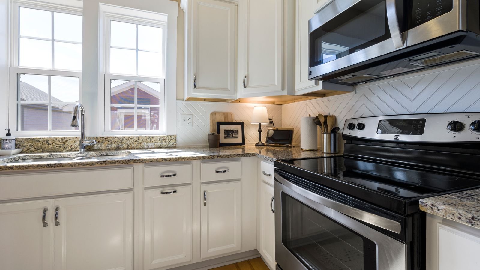 Modern kitchen with stainless steel appliances and countertop outlets