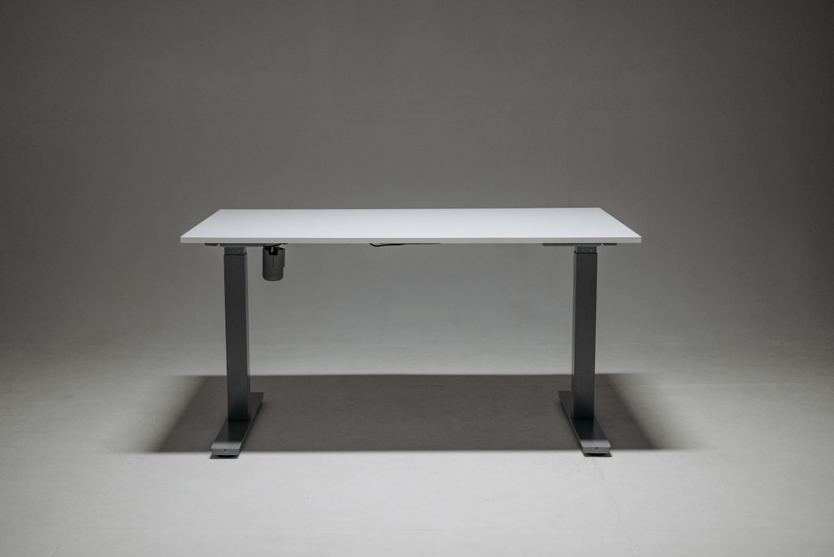Adjustable standing desk frame supporting monitors and equipment