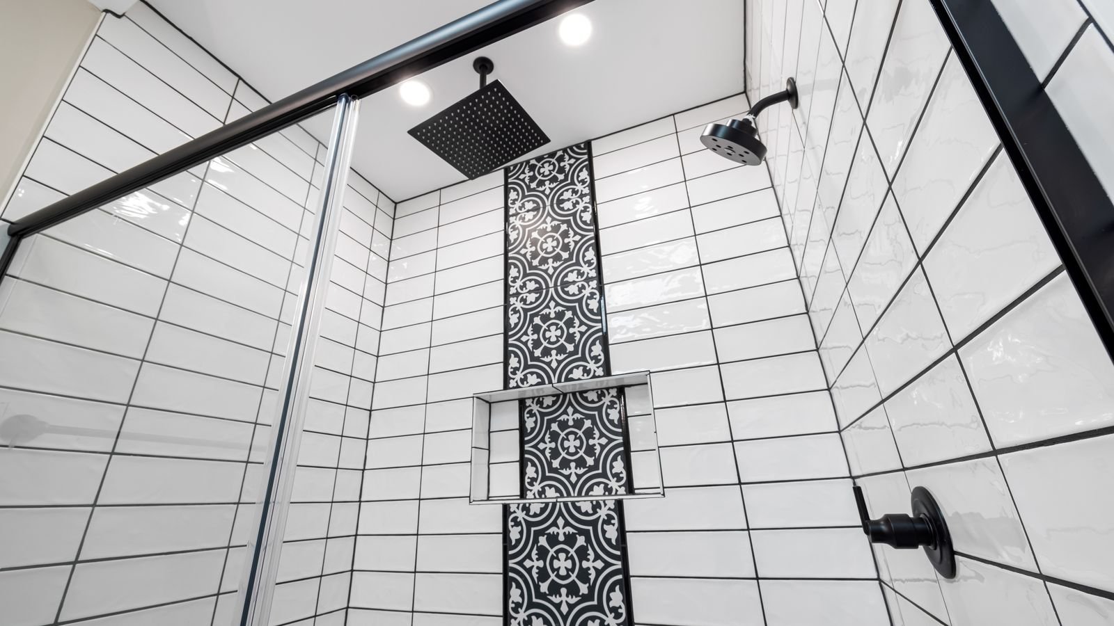 Close-up of shower floor tile and sealed grout joints in a bathroom