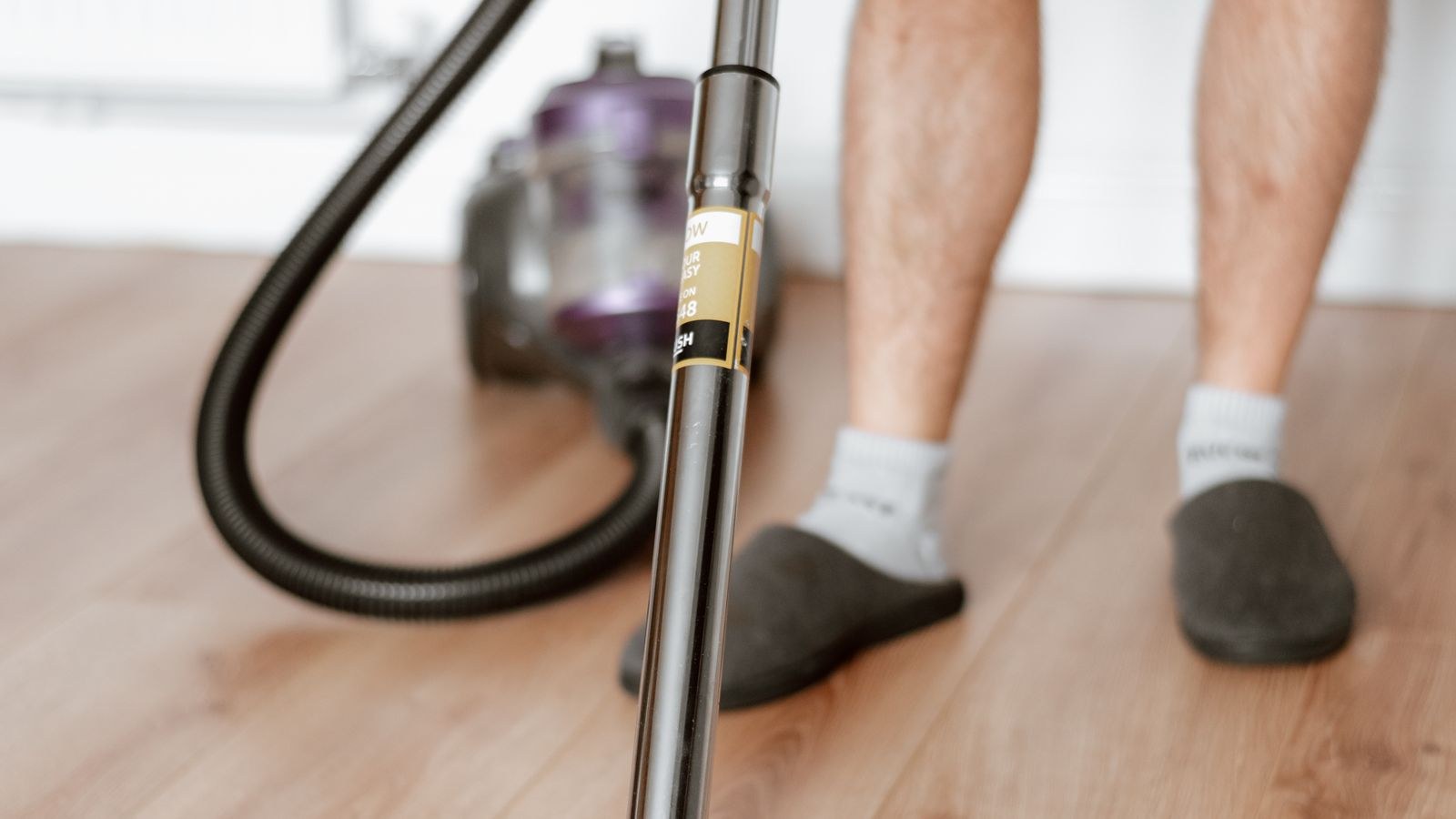 Wet dry shop vacuum standing on a garage floor after a water cleanup job